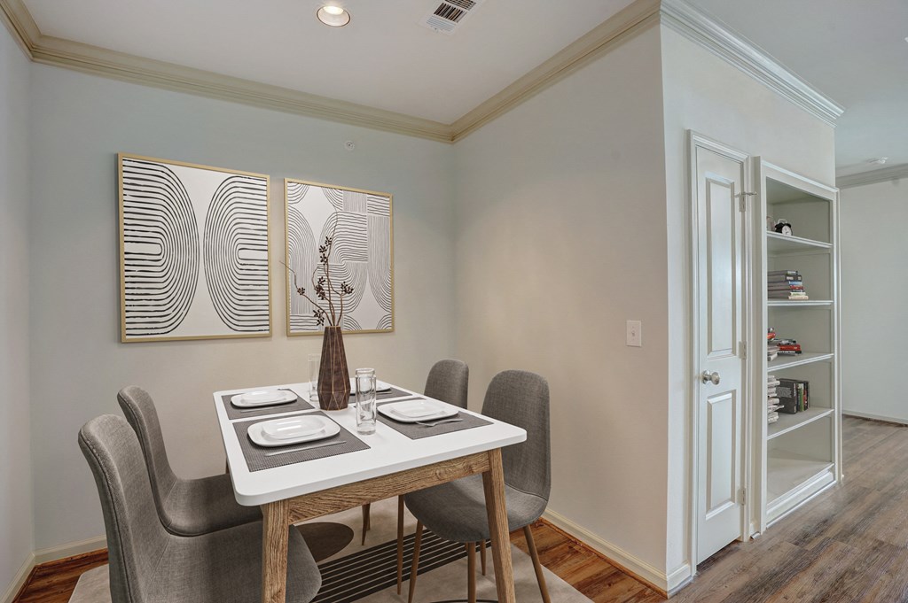a dining room with a table and chairs and a door to a closet