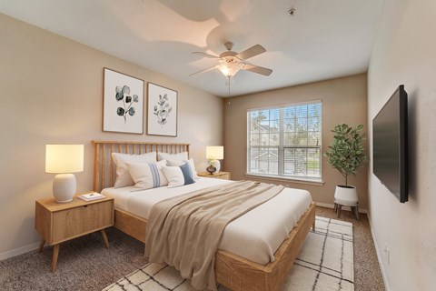 a bedroom with a large bed and a ceiling fan