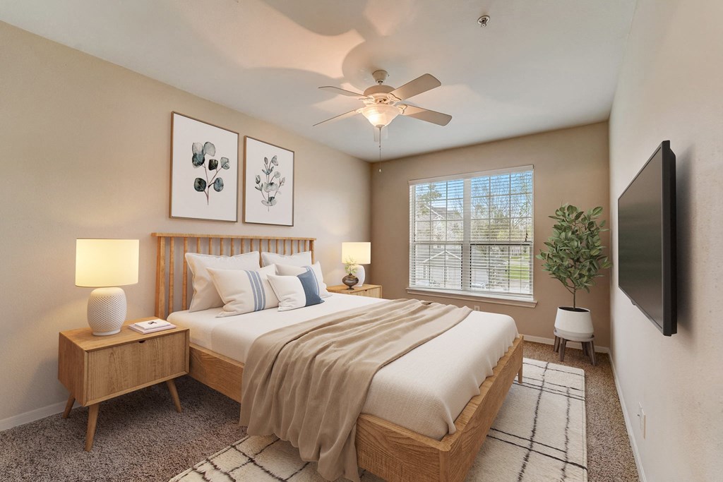 a bedroom with a large bed and a ceiling fan