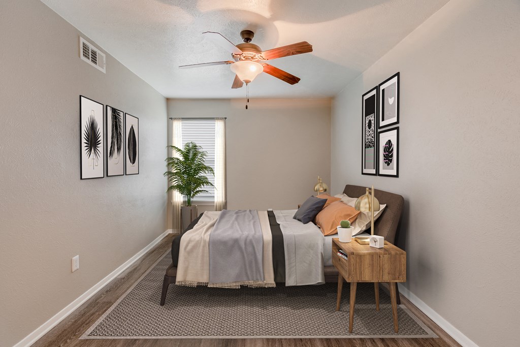 an open bedroom with a bed and a ceiling fan
