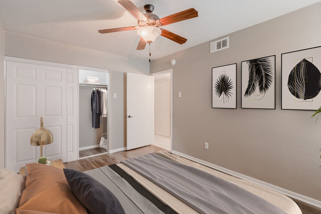 a bedroom with a bed and a ceiling fan