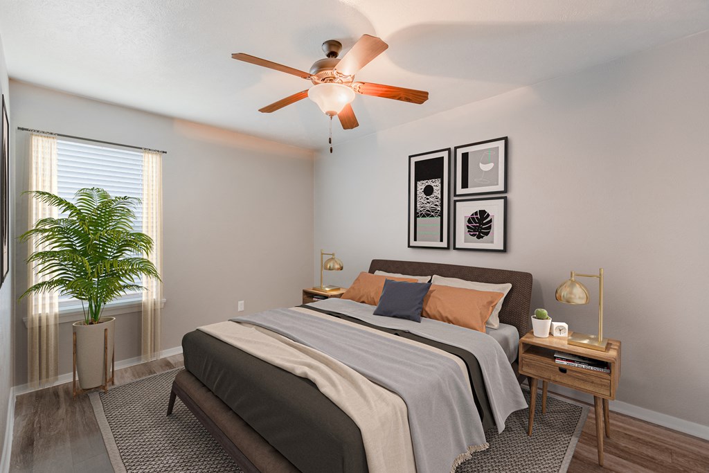 a bedroom with a large bed and a ceiling fan