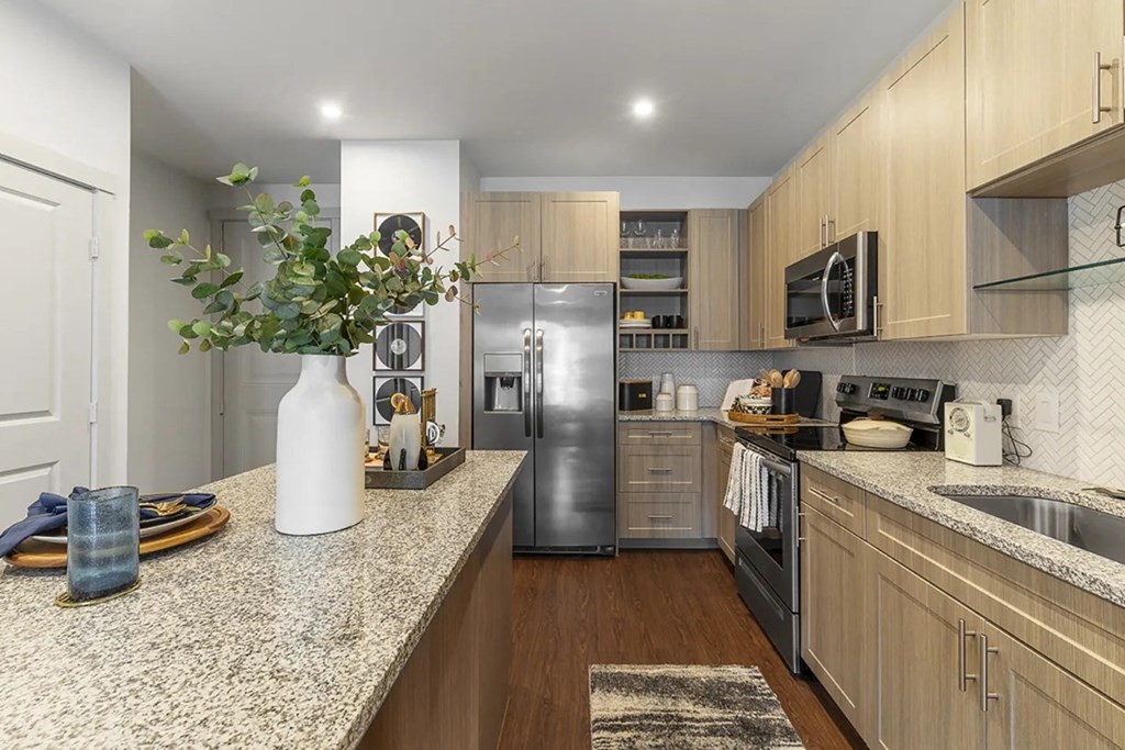 a kitchen with granite counter tops and stainless steel appliances