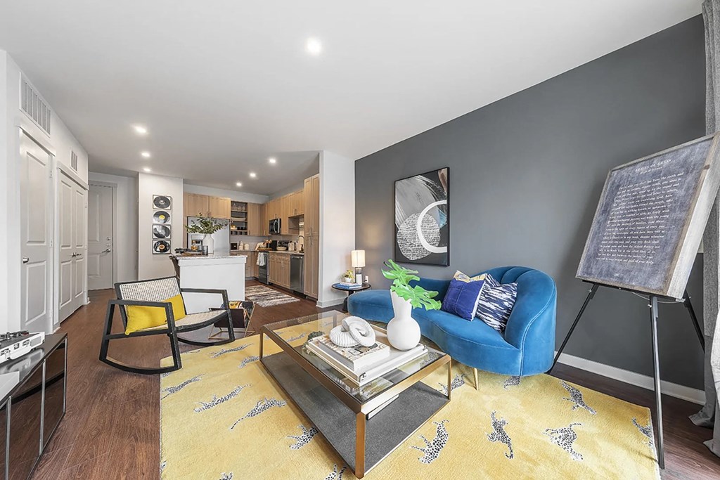 a living room with a blue couch and a table