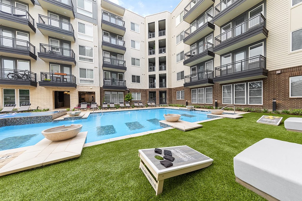 an apartment building with a pool in the middle of it