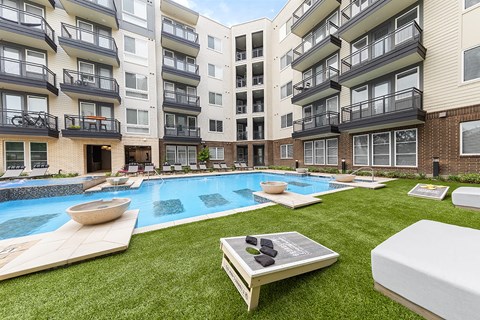 an apartment building with a pool in the middle of it