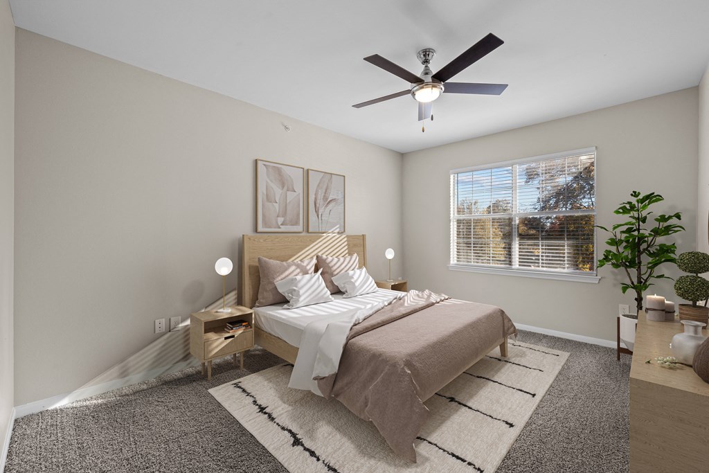 a bedroom with a large bed and a ceiling fan