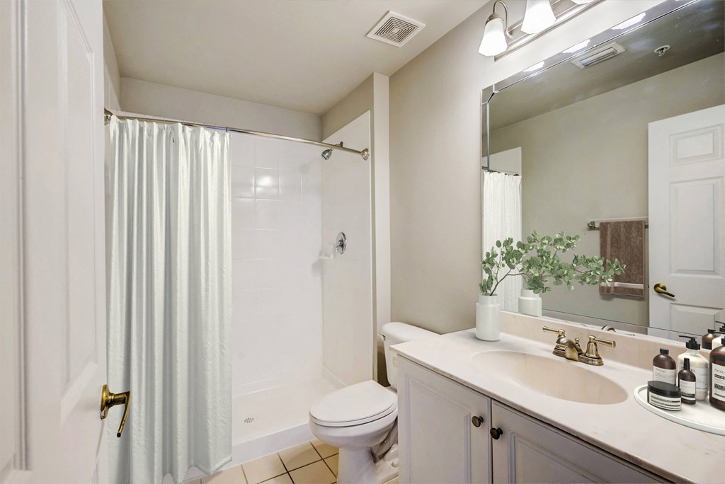 a bathroom with a shower and a sink and a toilet