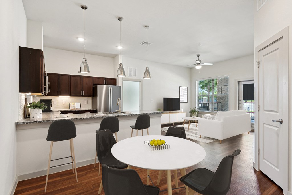 a kitchen and dining room with a white table and chairs