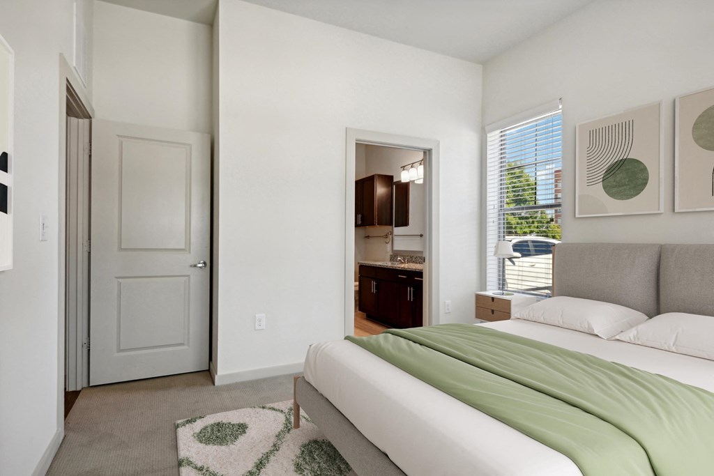 a bedroom with a bed and a door to a bathroom