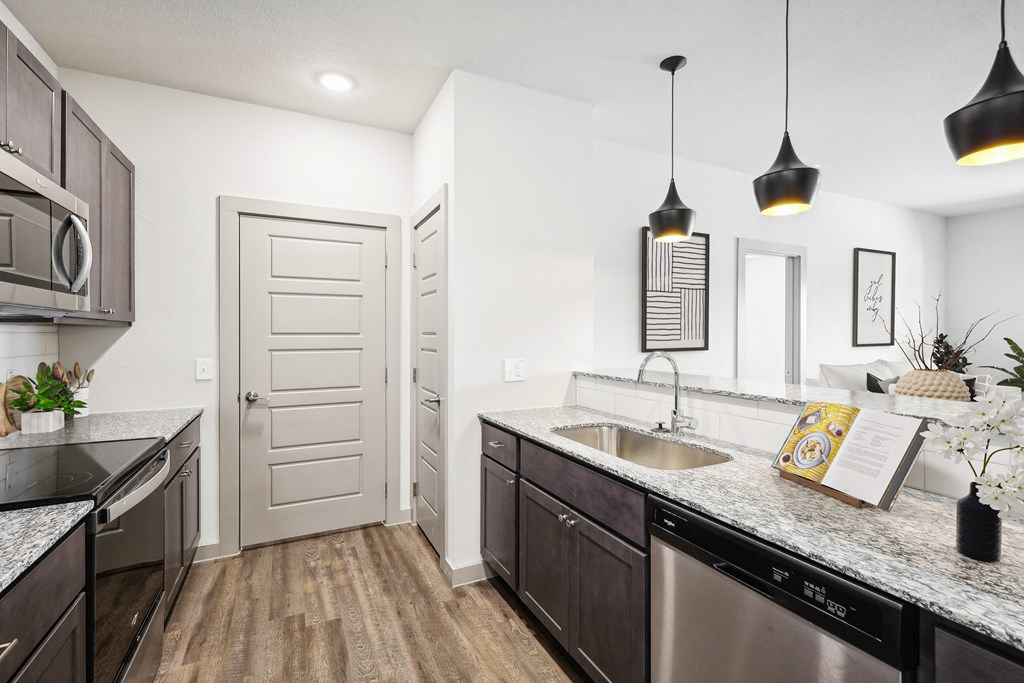 an open kitchen with granite counter tops and stainless steel appliances