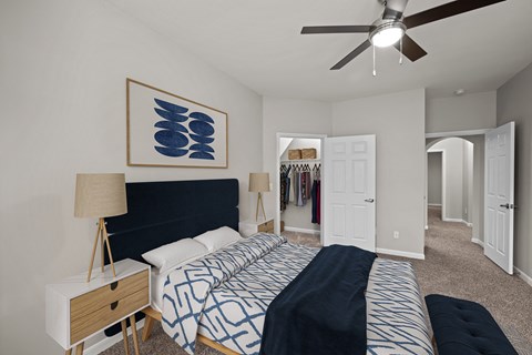 a bedroom with a large bed and a ceiling fan