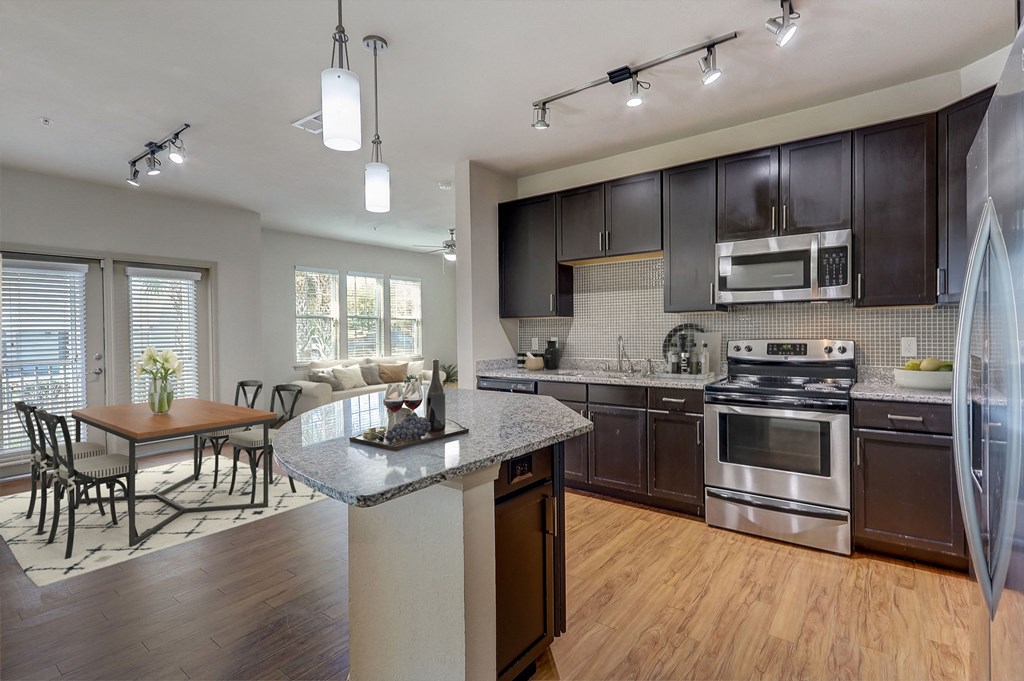 a kitchen with stainless steel appliances and a granite counter top