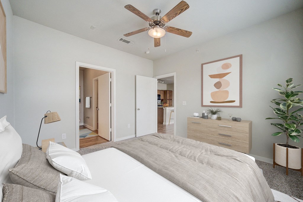 a bedroom with a bed and a ceiling fan