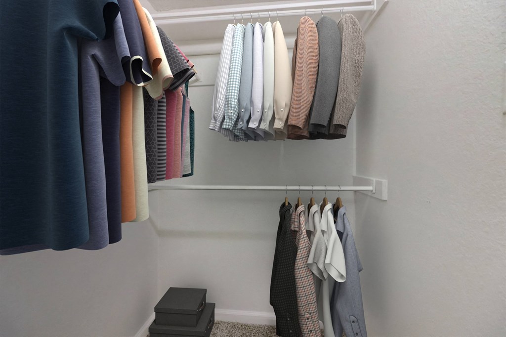 a row of clothes hanging on a rack in a closet