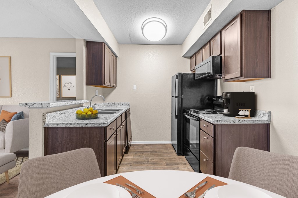 our apartments have a kitchen and dining room with a table and chairs