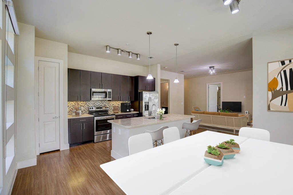 a kitchen and dining room with a white table