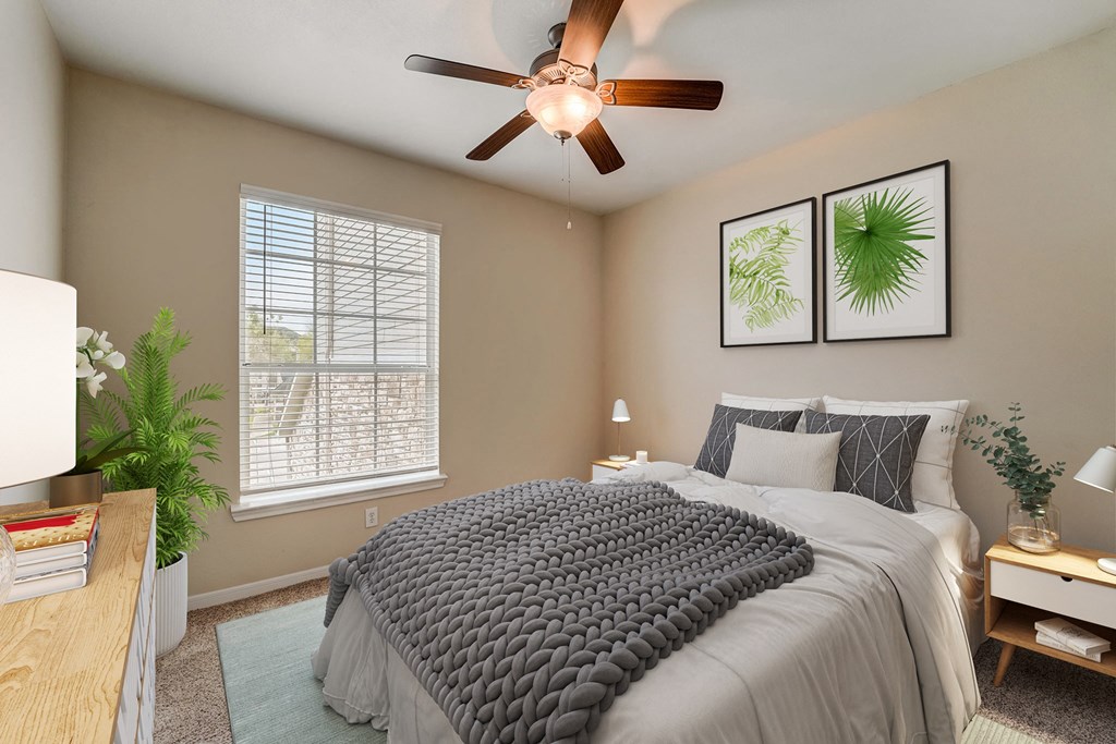 a bedroom with a large bed and a ceiling fan