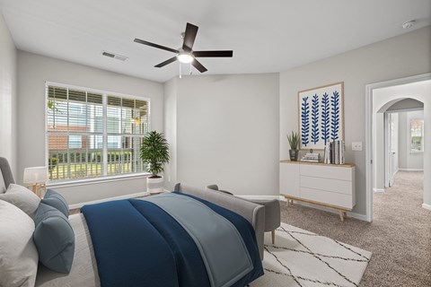 a bedroom with a bed and a ceiling fan