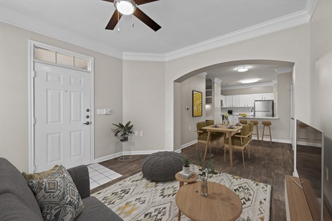 a living room with a couch and a dining room table