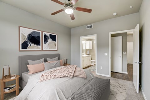 a bedroom with a large bed and a ceiling fan