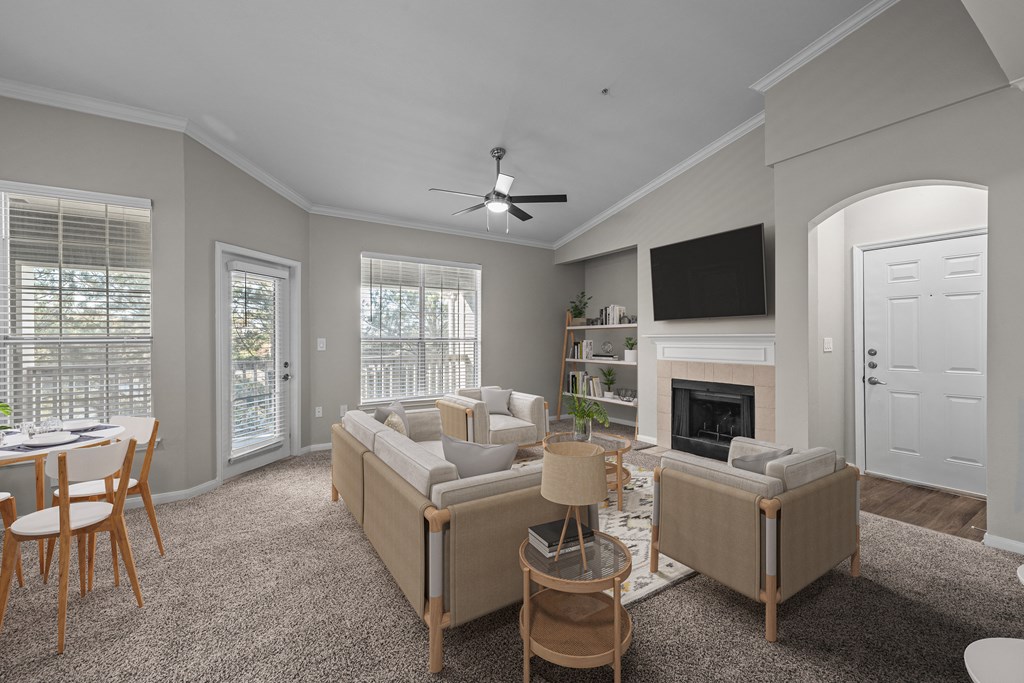 a living room with couches and chairs and a fireplace