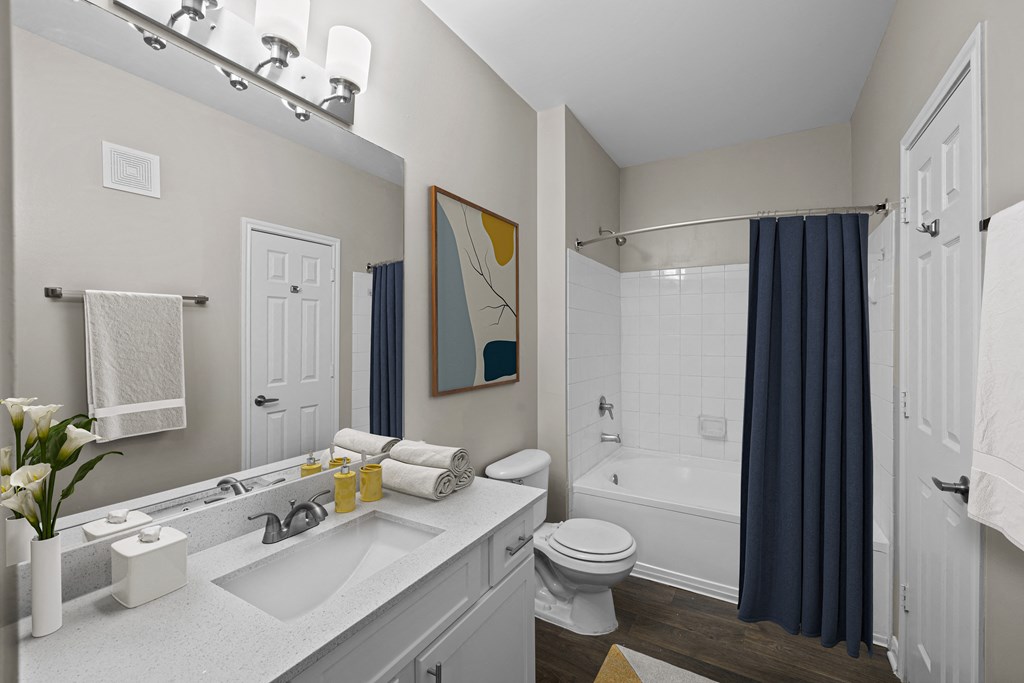 a bathroom with a shower and a sink and a toilet