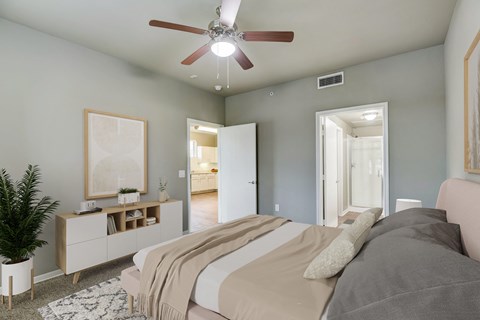 a bedroom with a large bed and a ceiling fan