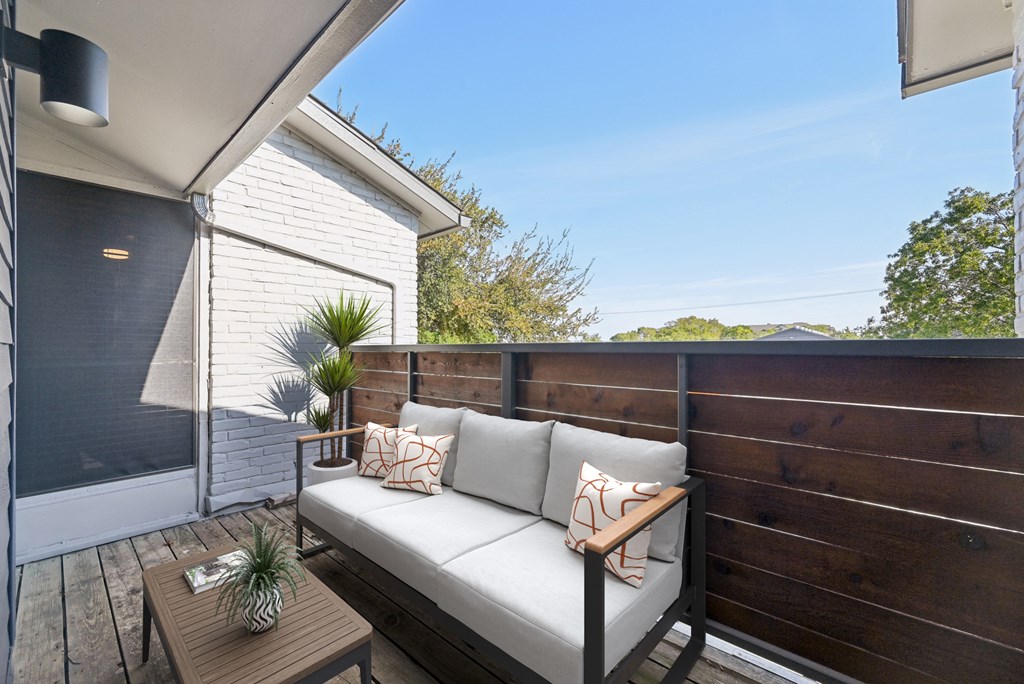 a balcony with a couch and a table
