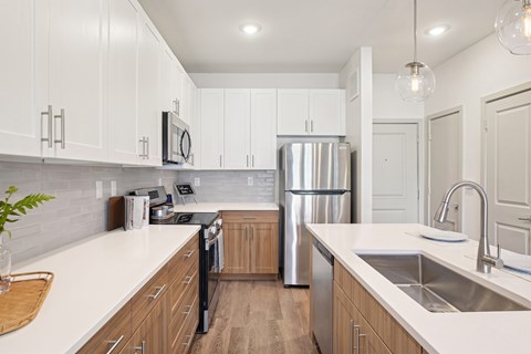 A modern kitchen with wooden cabinets and stainless steel appliances.