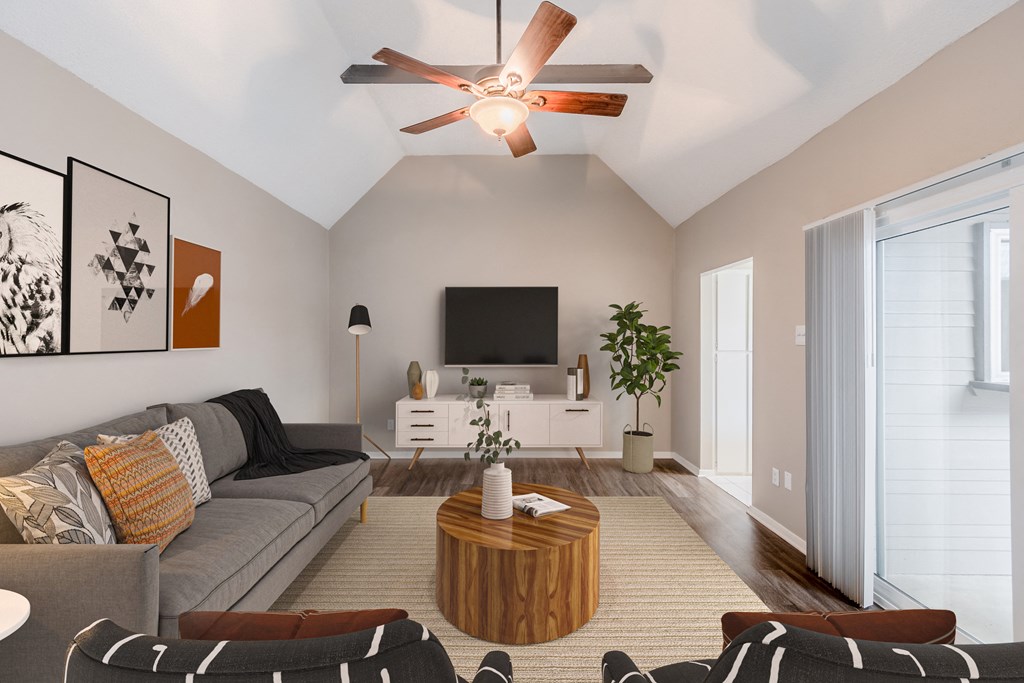 a living room with a couch and a ceiling fan