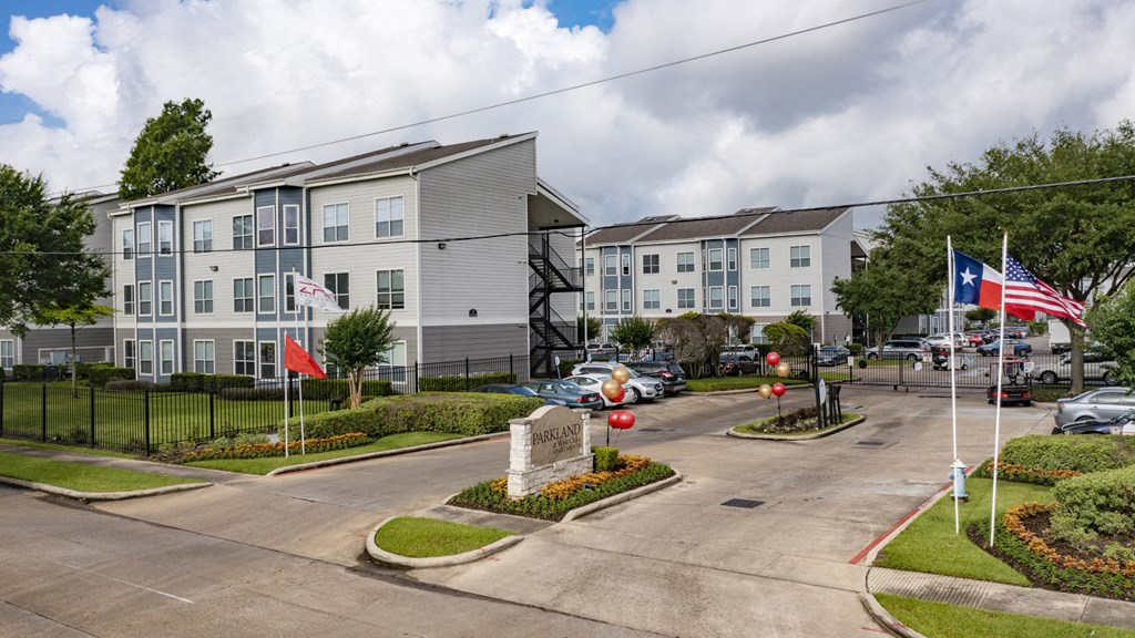 a city street with flags in front of apartment buildings