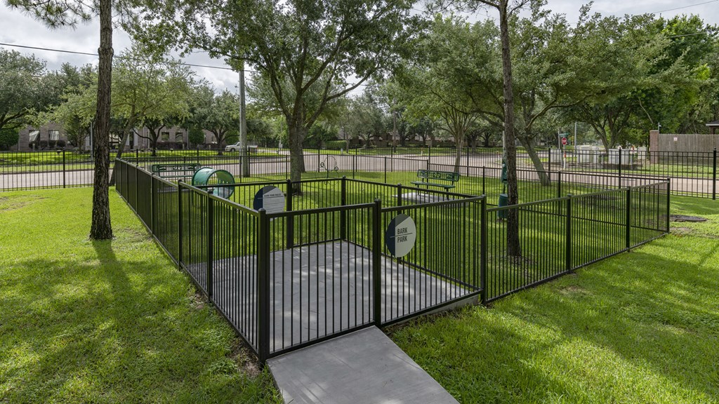 an iron fence around a playground in a park