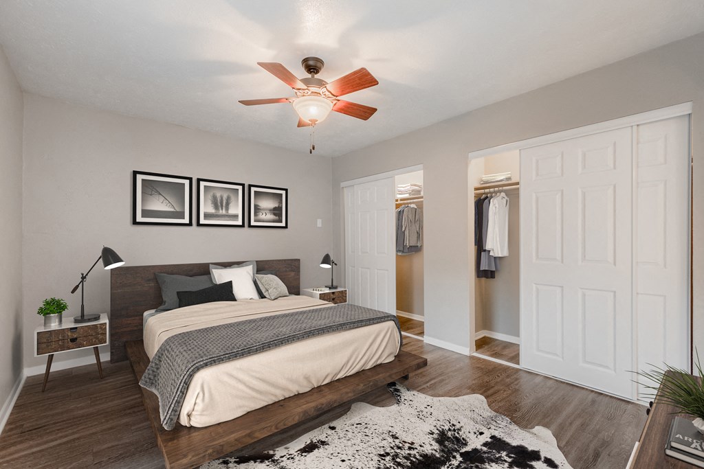 a bedroom with a large bed and a ceiling fan