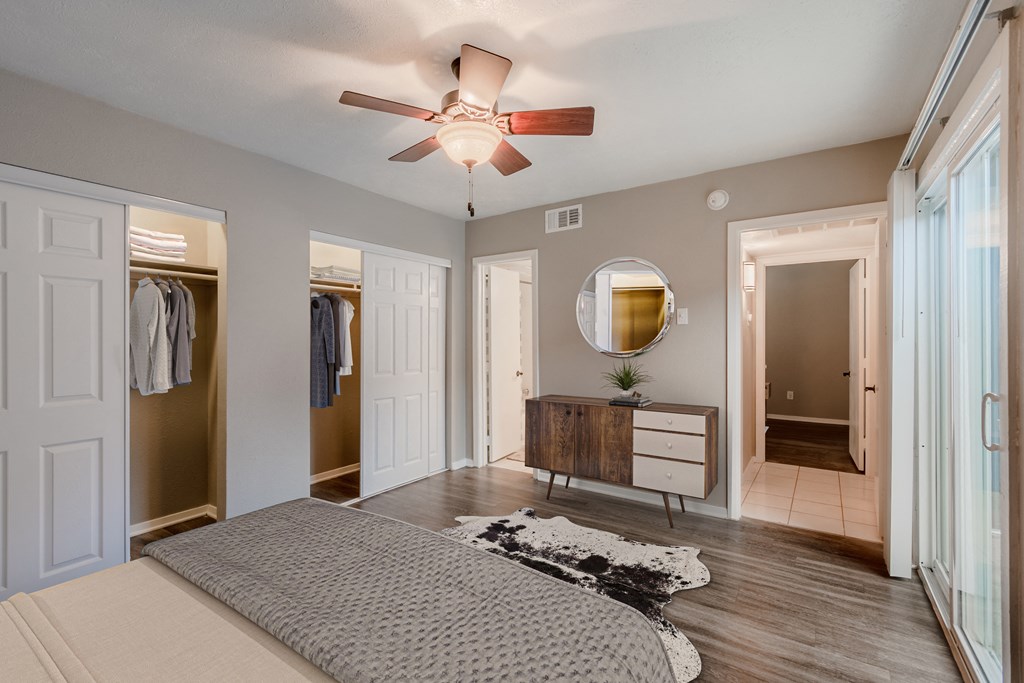 a bedroom with a bed and a ceiling fan