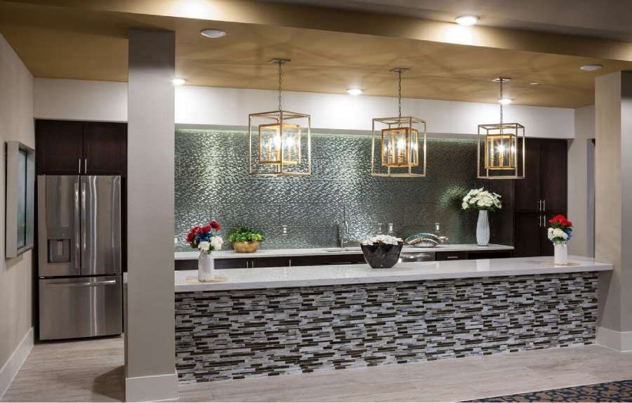 a kitchen with a counter and a stainless steel refrigerator