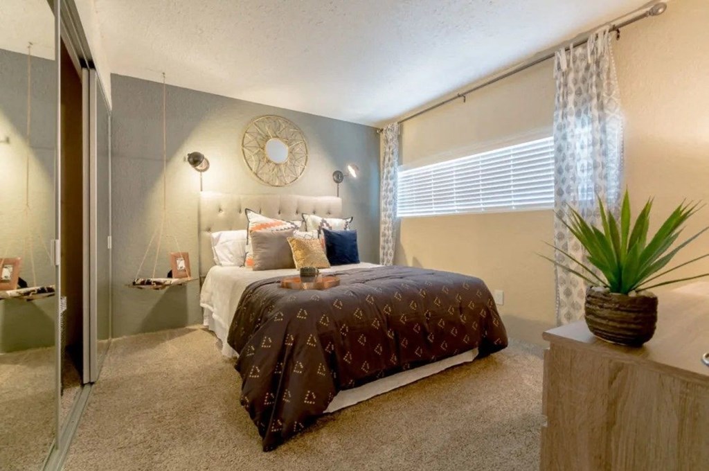 a bedroom with a bed and a plant