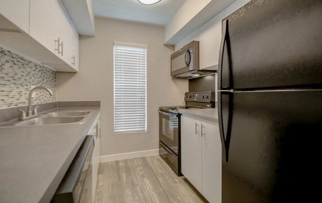 a kitchen with a sink and a refrigerator