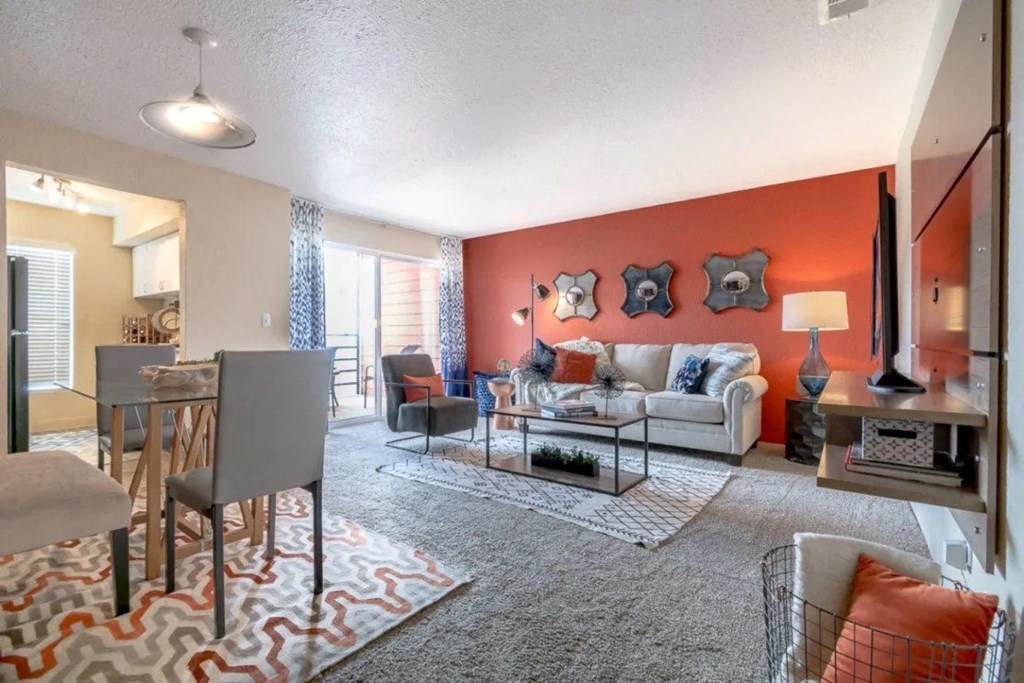 a living room and dining room with a couch and a table