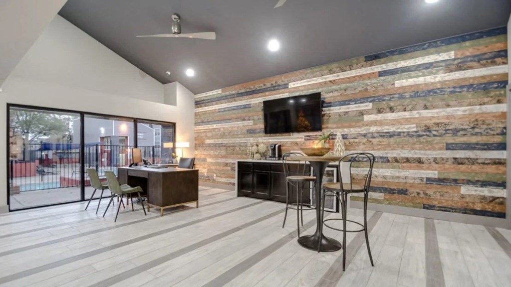 the lobby of a building with a bar and a television