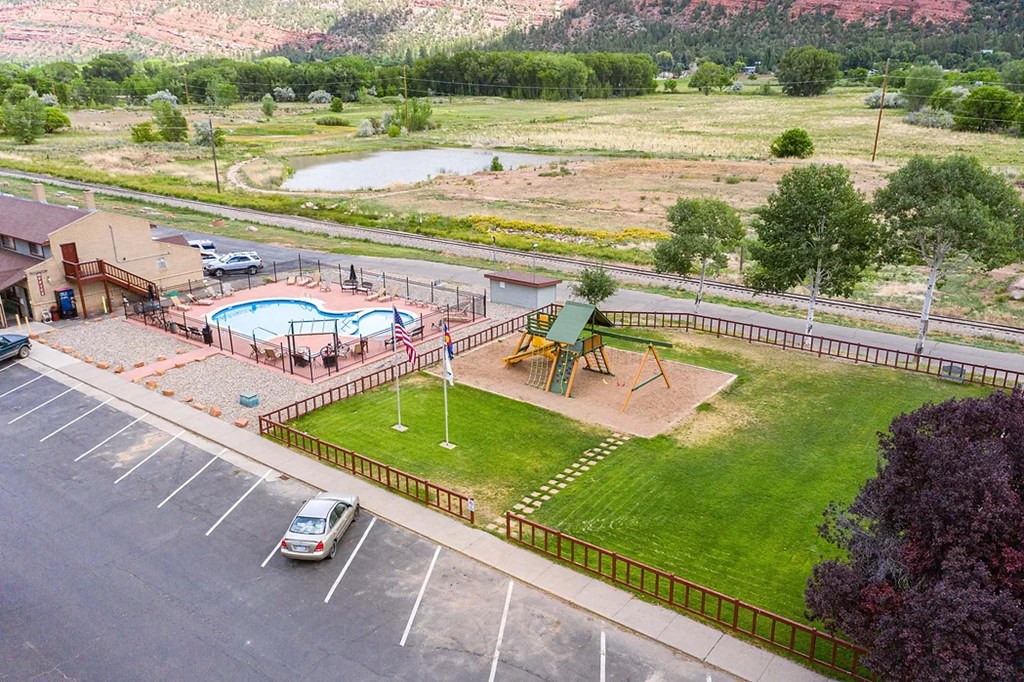 a view of the playground and pool from the top of the building