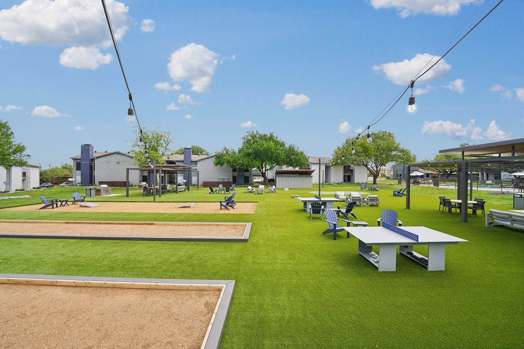 a park with picnic tables and benches on the grass