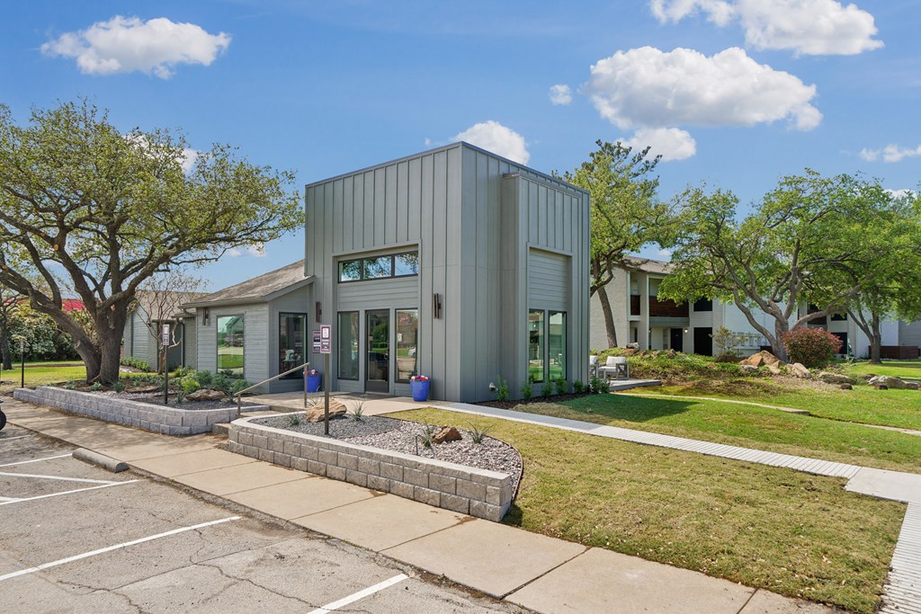 a small house with a sidewalk in front of it