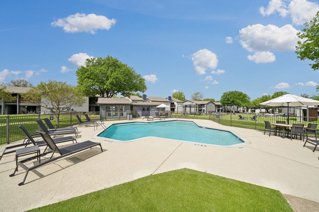 the preserve at ballantyne commons pool and patio with chairs and umbrellas
