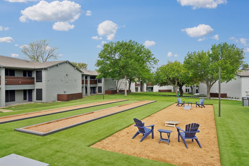 our apartments have a large yard with tables and chairs
