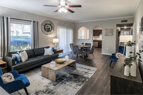 A living room with a grey couch and a wooden coffee table.