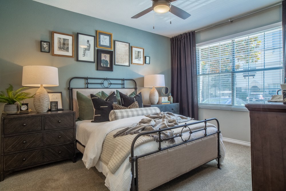 a bedroom with a bed and a ceiling fan