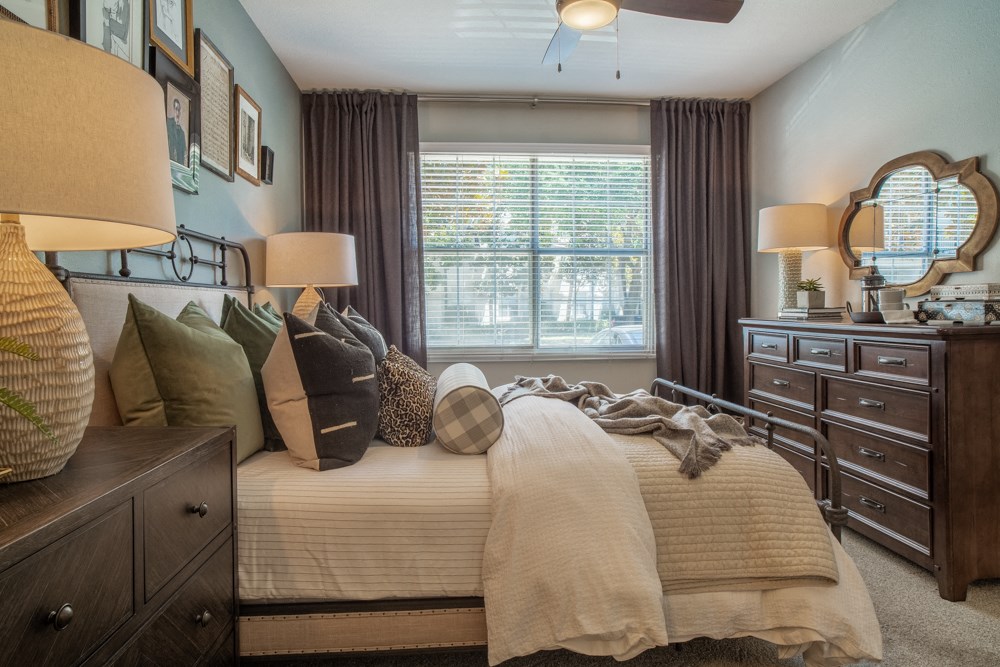 a bedroom with a bed with pillows and a window