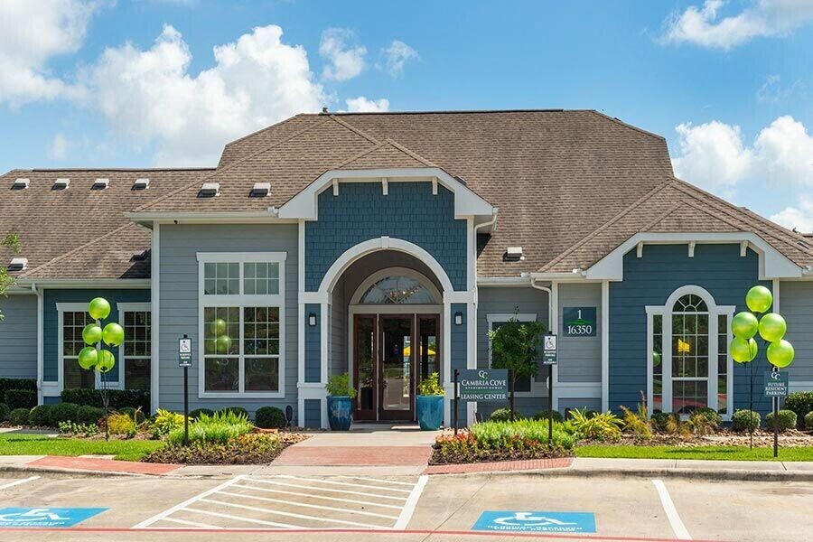 a blue building with balloons in front of it