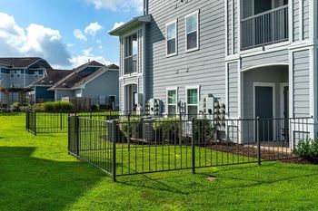 a house with a wrought iron fence in front of it